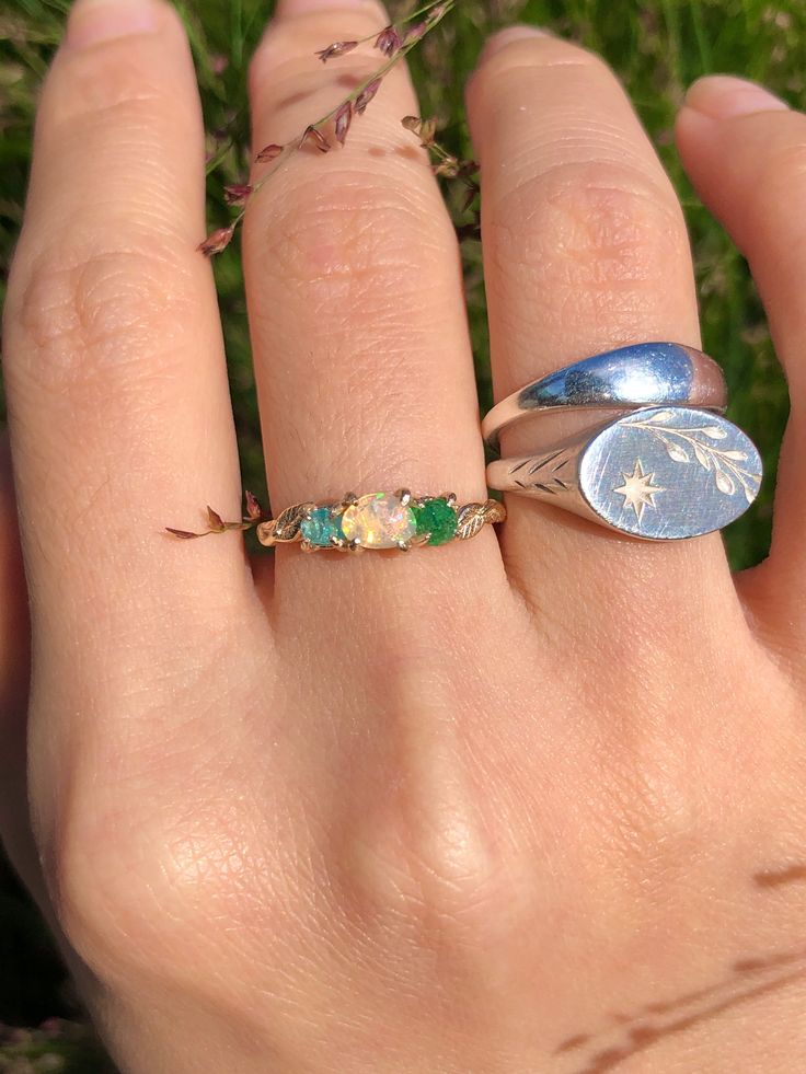 This Earthy Opal Engagement Ring is the perfect way to wrap your hands in love. These Rings are made with genuine Raw free-formed Opal, emerald and aquamarine in their natural state. It's crafted in a Solid Sterling silver/14k/18k Gold Specification: Gemstone: Raw Opal, emerald, aquamarine Center Opal Size: 4.5mm*5.5mm Materials: Solid Sterling Silver, Solid 14k/18k Gold Style: Engagement Ring *Gems: The raw gems natural hues vary, adding an organic touch to your ensemble. I'll try to select the Spiritual Emerald Gemstone Ring, May Birthstone Ring In Tsavorite, Tsavorite Birthstone Ring For May Birthstone Gift, Heirloom Style Opal Ring Gift, Heirloom Style May Birthstone Jewelry For Promise, Green Three Stone Birthstone Ring In 14k Gold, Fine Jewelry Opal Promise Ring With Birthstone, Unique Emerald Ring For May Birthstone, Fine Jewelry Opal Ring For Promise