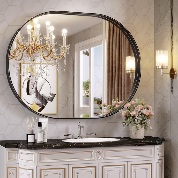 a bathroom vanity with a mirror and chandelier