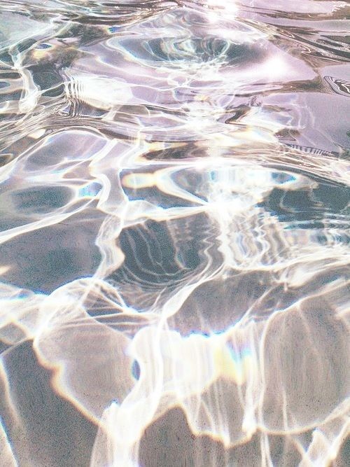 the water is crystal clear and reflecting sunlight