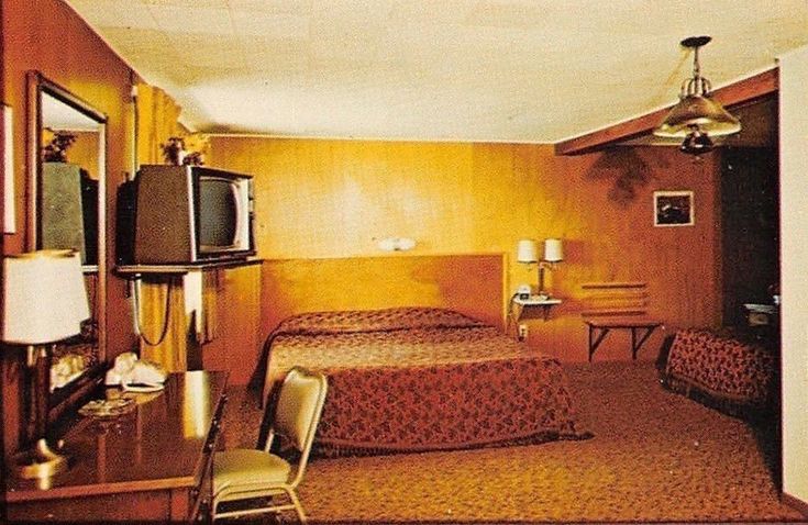 a hotel room with two beds and a television