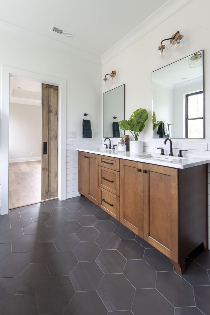 a large bathroom with two sinks and mirrors