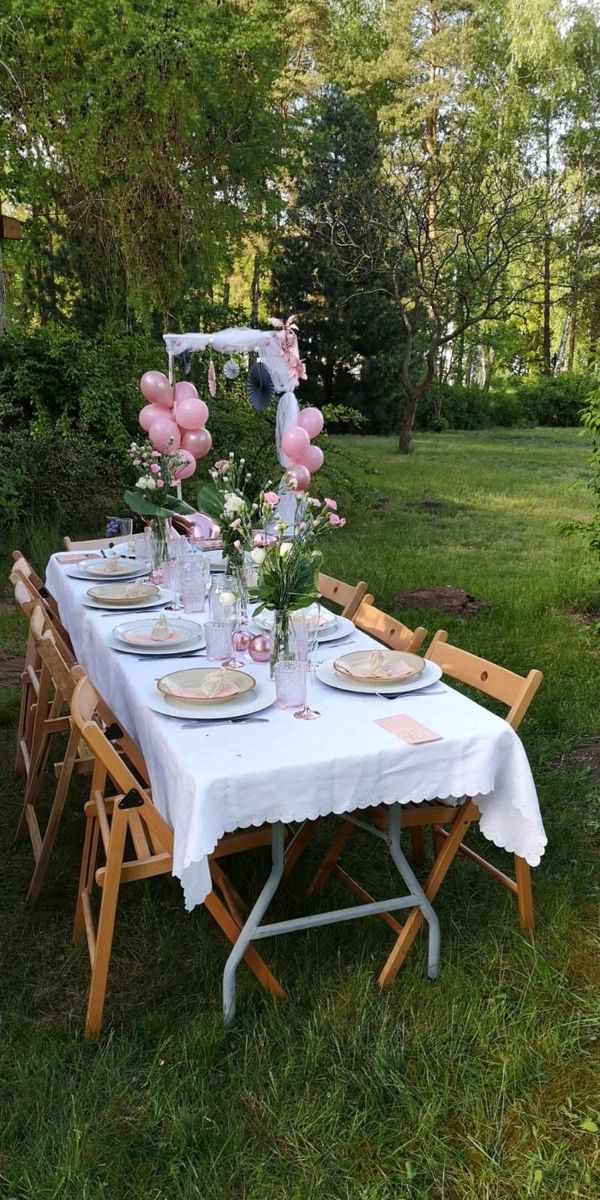 a table set up with balloons and plates