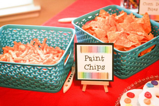 the table is set up with different types of chips and cupcakes on it