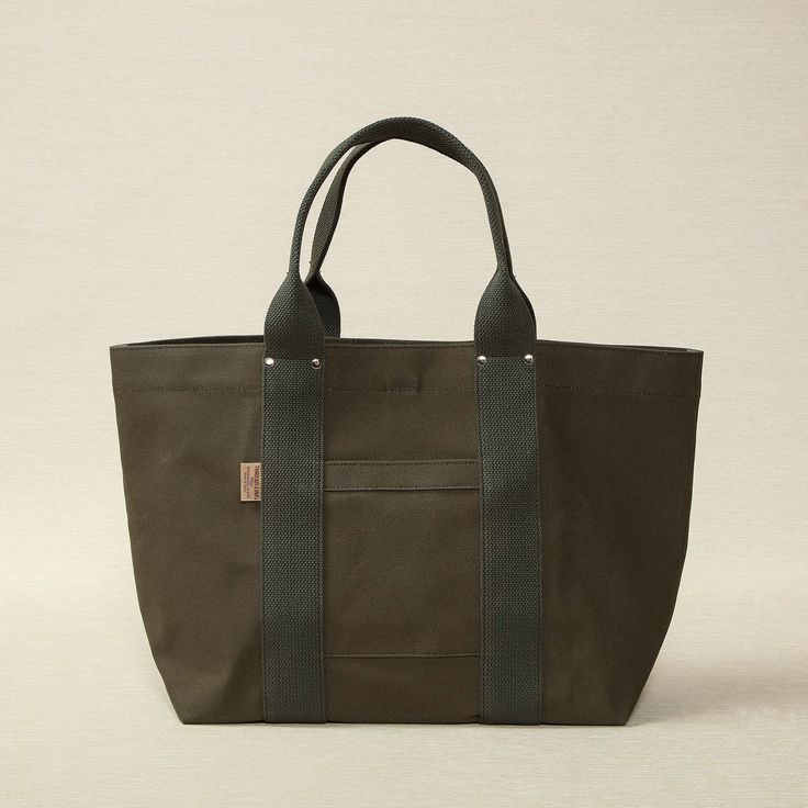 Heavy weight canvas tote 21.6" x 6.7" x 12.6" made in Japan Threadline is a Japanese-manufactured line of heavy canvas bags designed for everyday use. Khaki Canvas Bag For On-the-go, Large Capacity Duck Canvas Bag For On-the-go, On-the-go Canvas Bag With Reinforced Handles, Cotton Canvas Bag With Top Carry Handle, Practical Canvas Shoulder Bag With Reinforced Handles, Modern Canvas Bag For Errands, Khaki Canvas Tote Bag With Canvas Lining, Duck Canvas Bag With Reinforced Handles For Daily Use, Travel Canvas Bag With Reinforced Handles