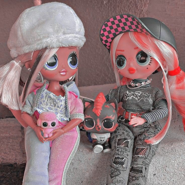 two dolls are sitting next to each other