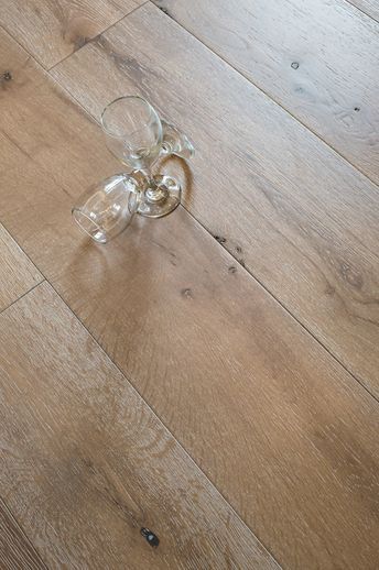 a wine glass sitting on top of a wooden floor