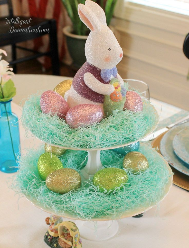 two tiered trays filled with easter decorations