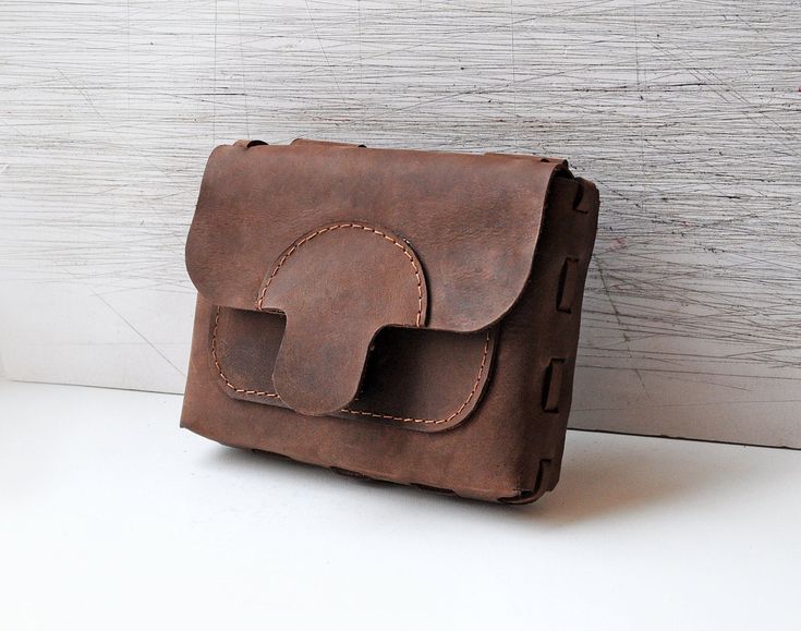 This leather belt bag is made of brown genuine leather with one front pocket and hidden metal closure. There are two leather loops on back side, so you can easily put it on your belt. It's perfect to hold you keys, cell phone, money or other small items. Very stylish and perfect for festivals or traveling. !!Bag without belt, if you would like a belt please contact us.!! Main color: Brown Material: Brown leather Metal closure Measurement: Width 18 cm (~7 inch) Height 14 cm (~5,5 inch) Depth 4 cm Belt Bag Leather, Traveling Bag, Leather Hip Bag, Festival Bag, Leather Belt Bag, Hip Bag, Burning Man, Main Colors, Latvia