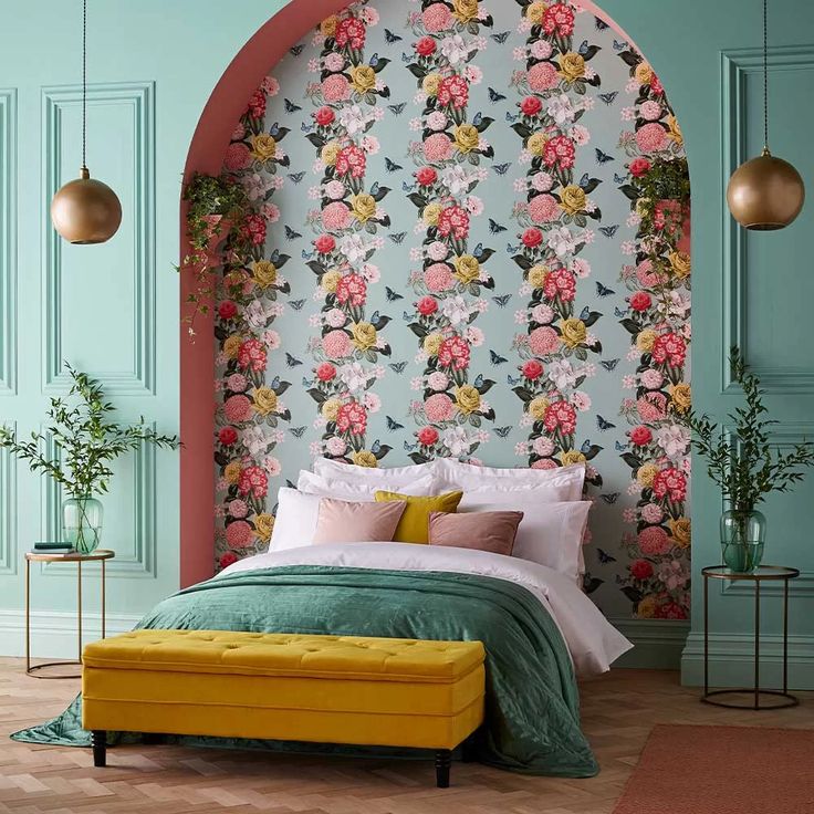 a bedroom with floral wallpaper and green walls