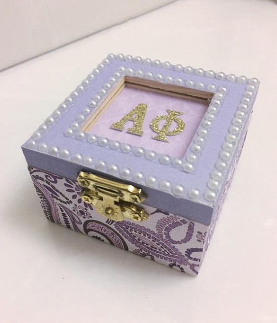 a purple and white box with the number forty four on it's side, decorated with pearls