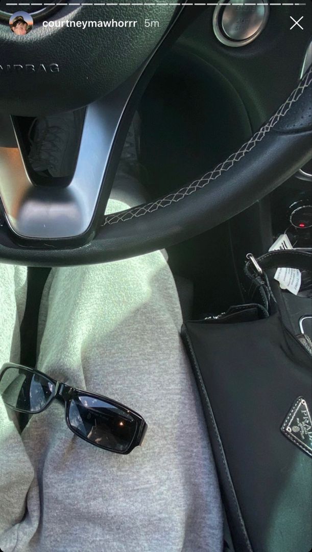 a pair of sunglasses sitting in the center console of a car