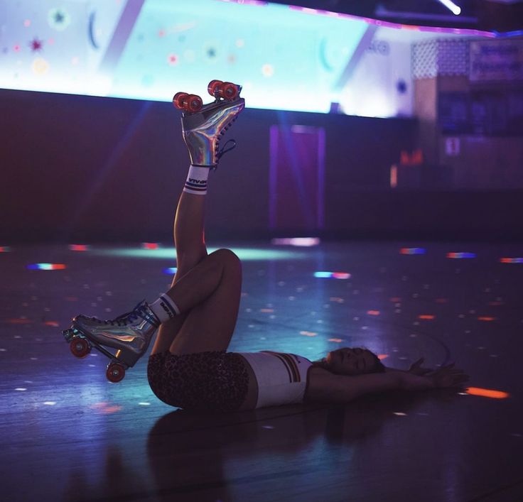 a woman is laying on the floor with her feet in the air while rollerblading