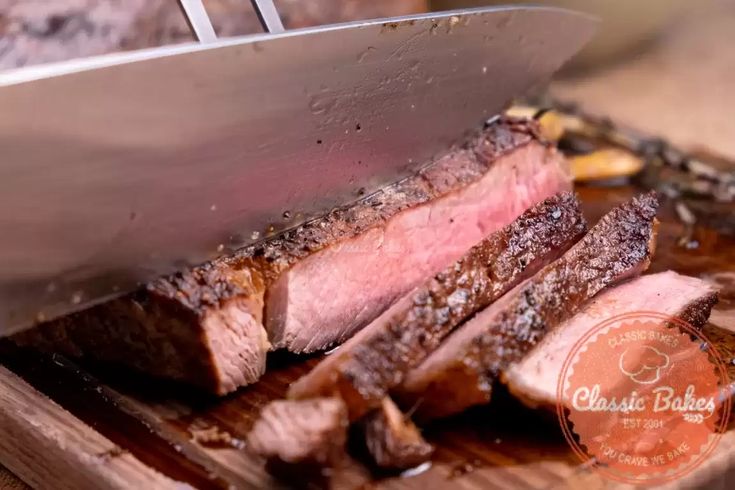 the steak is being cut into pieces on the cutting board