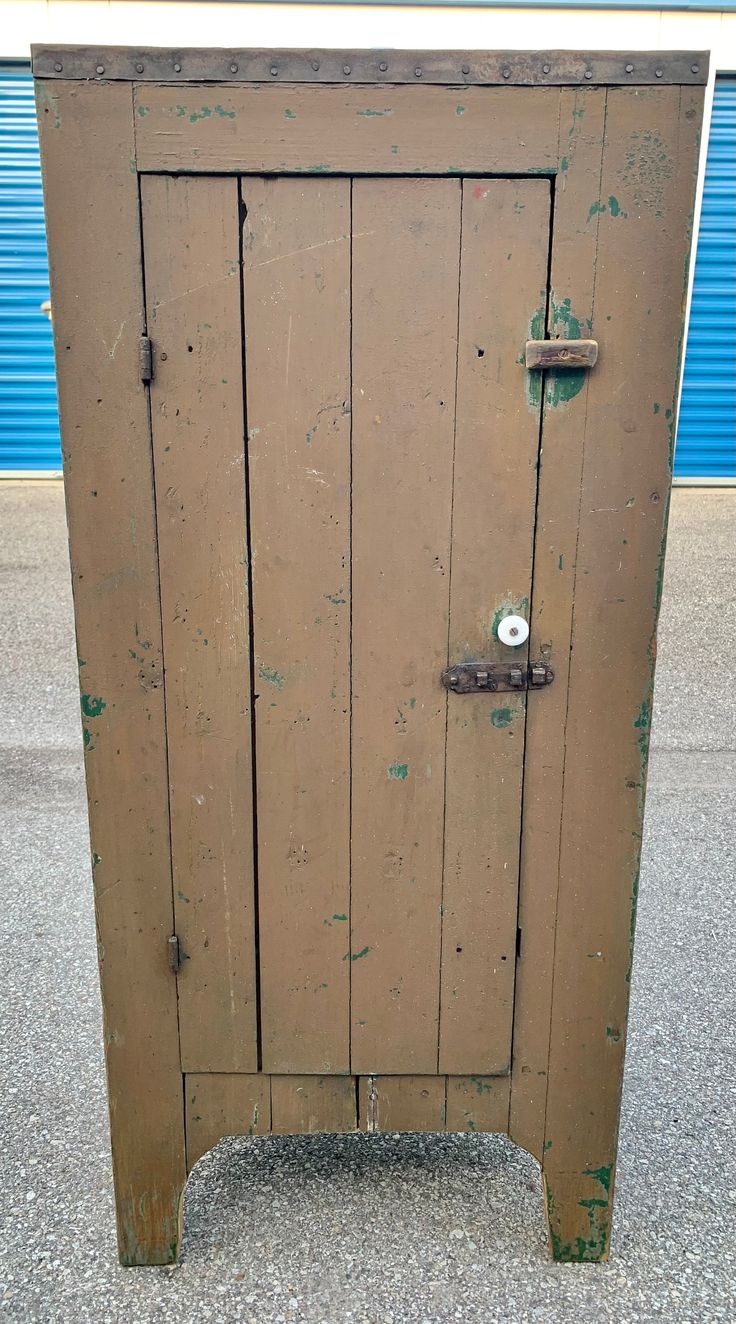 an old wooden cabinet sitting on top of a sidewalk