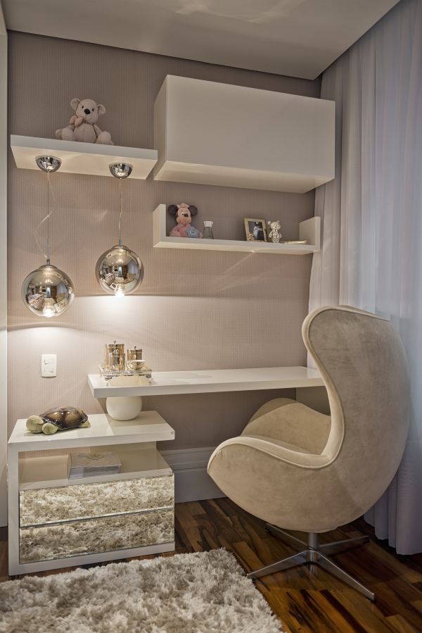 a white chair sitting in front of a window next to a shelf filled with books