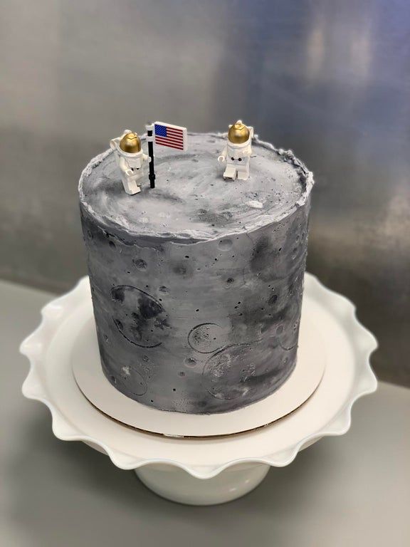 an image of a cake that looks like it is made out of moon land and stars