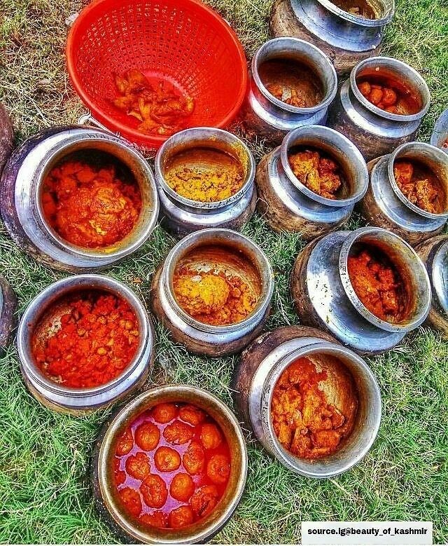 there are many metal bowls with food in them on the ground next to each other