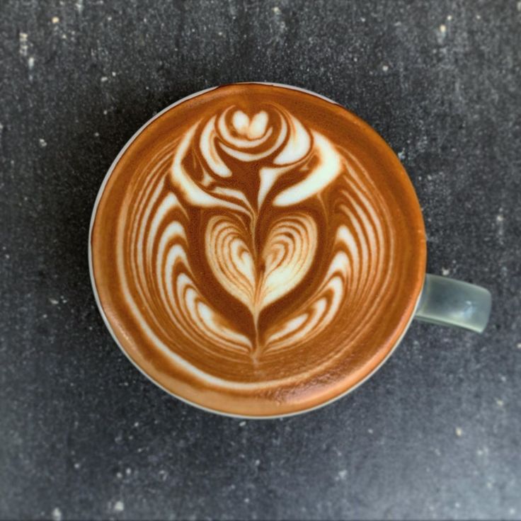 a cappuccino with an intricate design on it