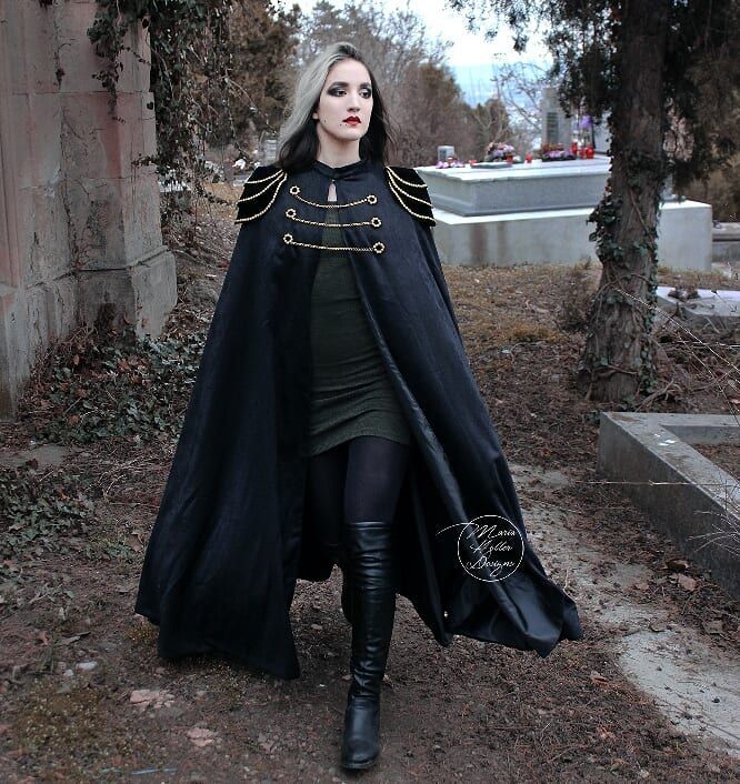 This long black cape is a new addition to my Etsy shop! Link in bio. 💖 It is fully lined and has epaulettes decorated with golden filigrees as well as 3 golden chains in the front. Do you like it? Let me know in the comments!  Cape & model: @maria.heller.designs  #blackcape #longcape #blackcloak #victoriangoth #militarycoat  #gothicstyle #gothstyle #gothicfashion #gothfashion #gothiccape #gothiccloak #gothiccoat #gothcape #gothcloak #gothcoat #blackcloak #witch #militarystyle #gothgirl #gothicg Cape Fantasy, Fantasy Cape, Gothic Cape, Gothic Fashion Victorian, Cape Outfit, Black Cloak, Cape Designs, Black Cape, Cool Baby