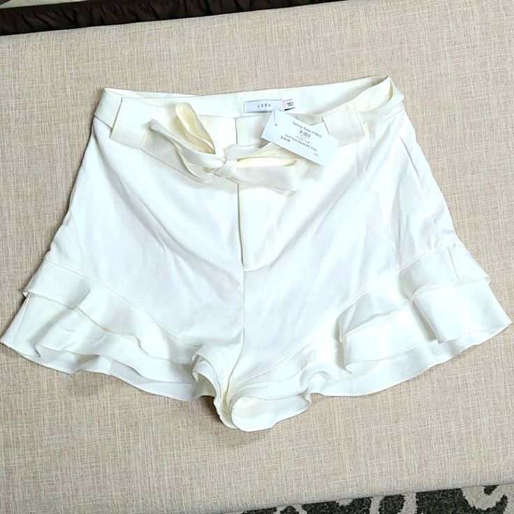 Cream Colored, Ruffled Leg Shorts With Built In Liner. Never Worn. Chic Shorts With Ruffle Hem, Chic Ruffle Hem Shorts, Elegant Ruffled Fitted Shorts, Chic Fitted Shorts With Ruffle Hem, Chic High Waist Ruffled Shorts, Chic High Waist Ruffle Shorts, Chic High-waisted Ruffled Shorts, Feminine Summer Bottoms With Ruffles, Feminine Ruffled Bottoms For Summer