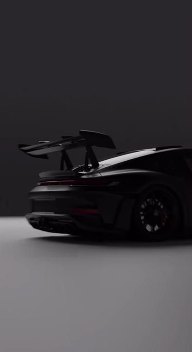 a black sports car is shown from the side with its doors open and wheels down