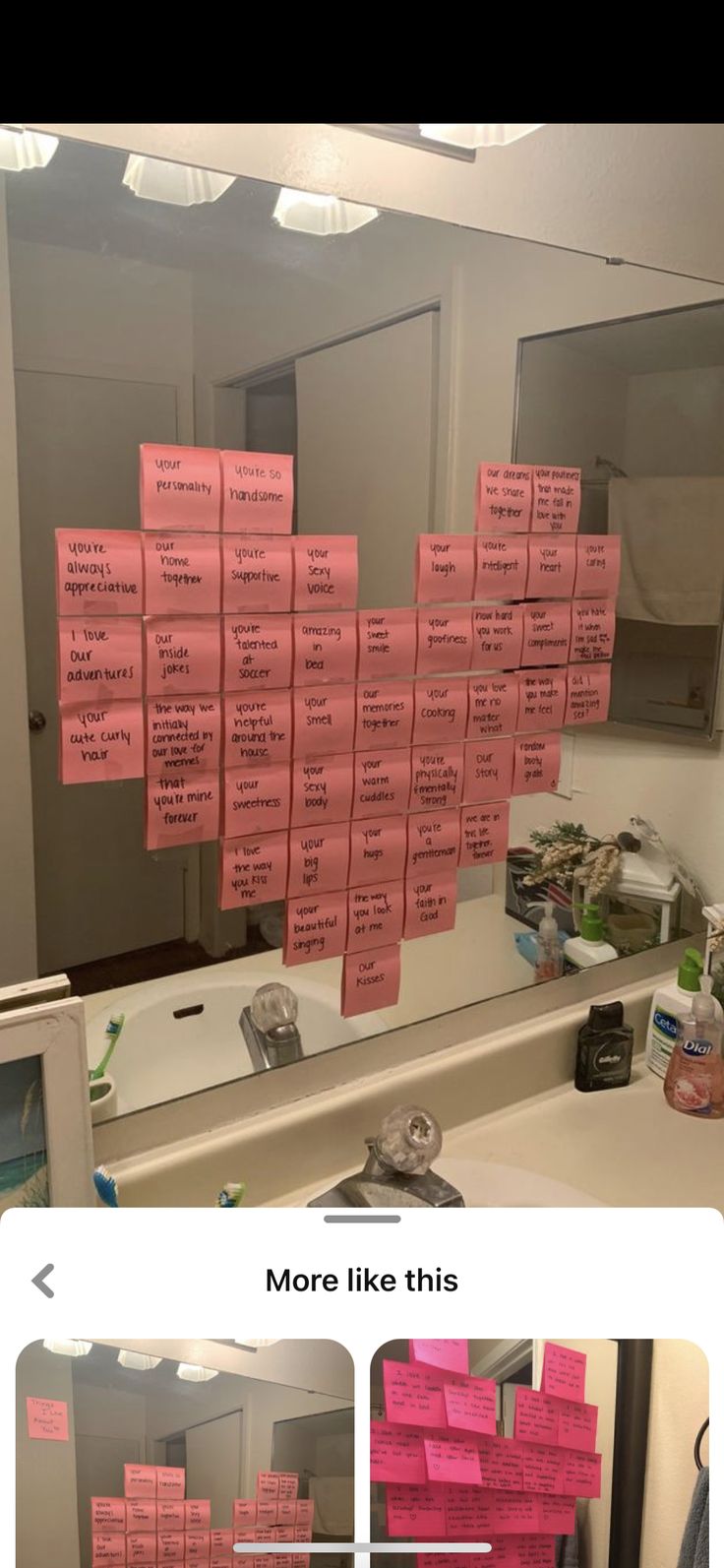 pink sticky notes stuck to the wall in front of a mirror