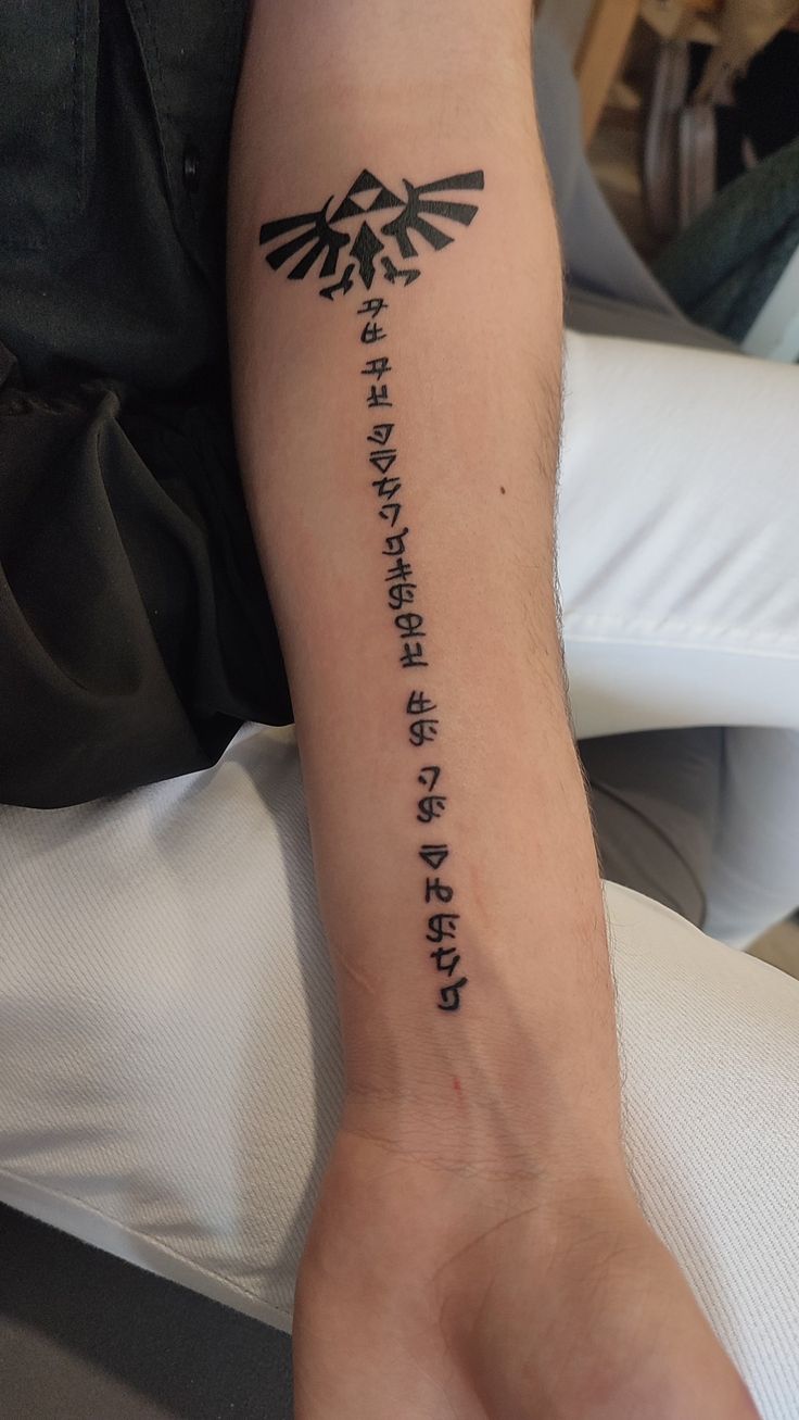 a person with a tattoo on their arm that has the words written in different languages