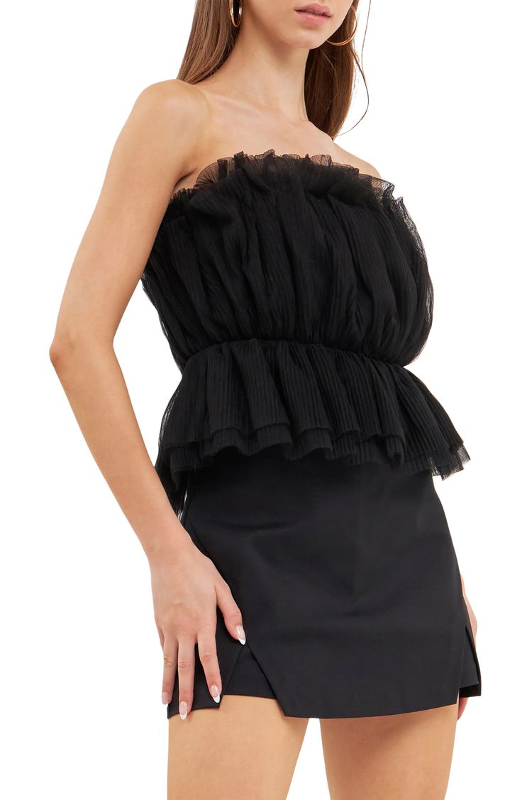 Turn up the drama with this textured tulle top featuring a strapless neckline and fabulous peplum. Strapless Lined 100% polyester Hand wash, dry flat Imported Chic Strapless Tube Top With Ruffles, Chic Strapless Ruffled Tube Top, Elegant Ruffled Bandeau Tube Top, Strapless Ruffled Tops For Evening, Evening Strapless Tops With Ruffles, Strapless Evening Tops With Ruffles, Strapless Ruffled Tube Top For Night Out, Flirty Strapless Top For Evening, Ruffled Bandeau Tube Top For Night Out