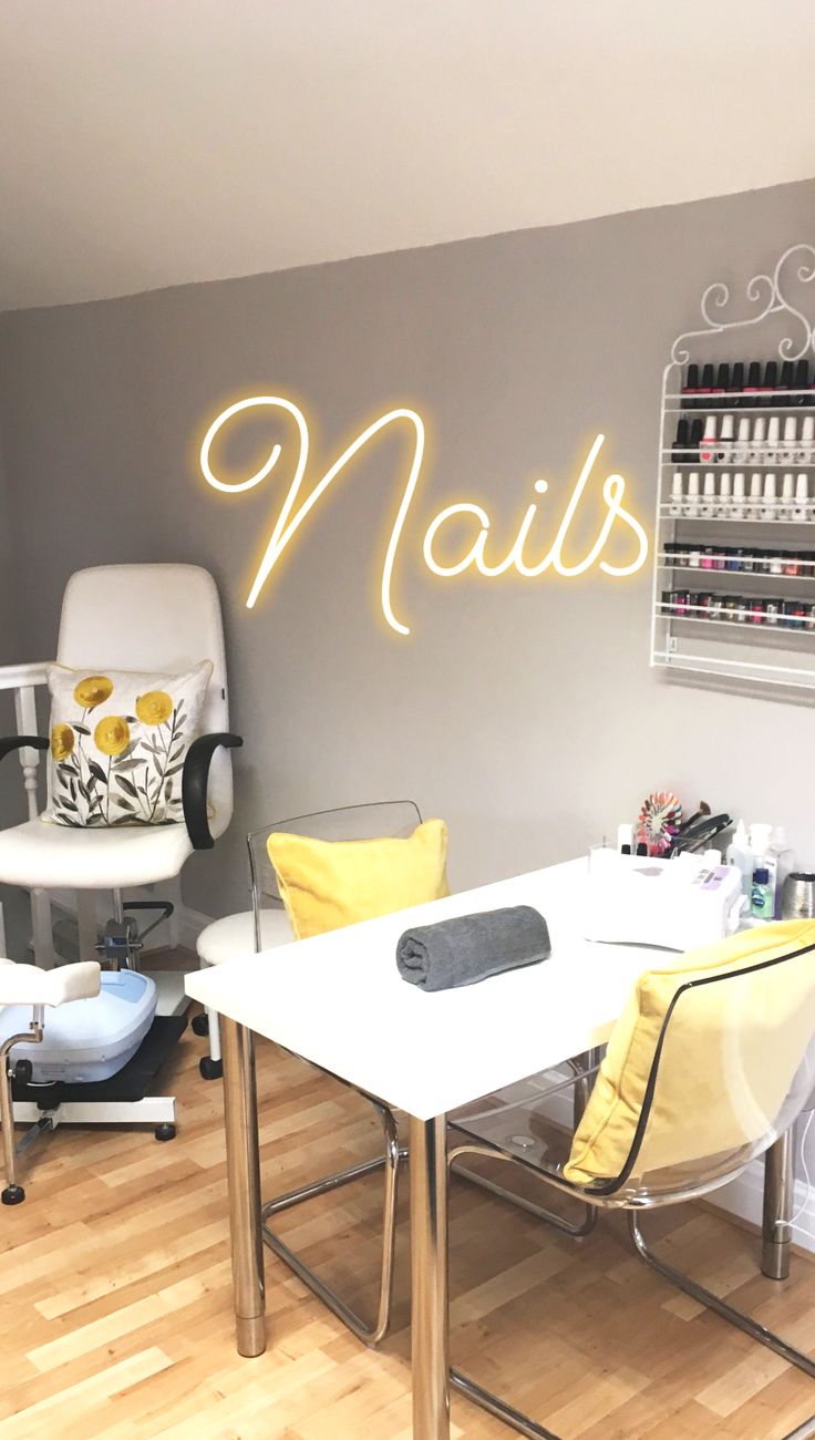 a nail salon with chairs and lights on the wall