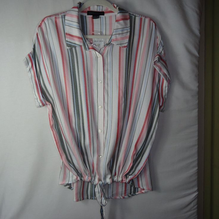 New With Tag Sanctuary Stripe Print Borrego Tie Shirt, Size Large. This 100% Rayon Button Front Top Has Pink, Red, Cream, Light Blue And Gray Vertical Stripes With Cuffed Cap Sleeves. It Has A Drawstring Tie Front With A High Low Hem.....Super Cute! Pit To Pit: 23" Shoulder To Hem: 25" In The Front And 28" In The Back Condition: New With Tags Multicolor Collared Top For Day Out, Casual Striped Button-up Tops, Casual Pink Top With Button Closure, Casual Multicolor Top With Button Closure, Multicolor Tops With Button Closure For Day Out, Casual Pink Blouse, Multicolor Relaxed Fit Top With Button Closure, Casual Multicolor Button-up Blouse, Relaxed Fit Multicolor Tops With Button Closure