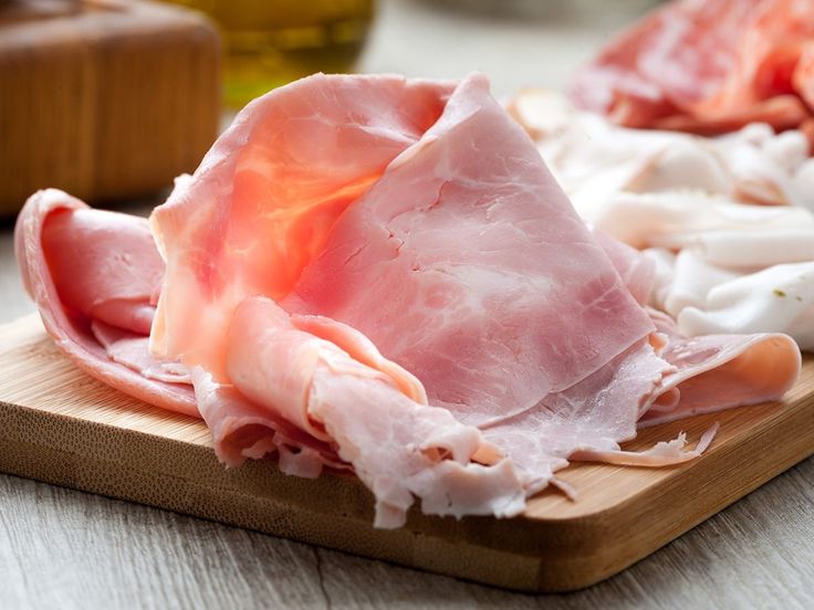 raw meats are on a cutting board ready to be cooked