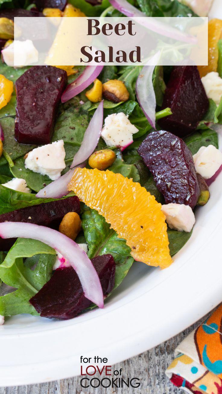 beet salad with feta cheese and oranges in a white bowl on a table