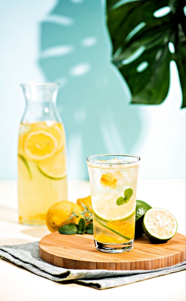 a wooden tray topped with two glasses filled with lemonade