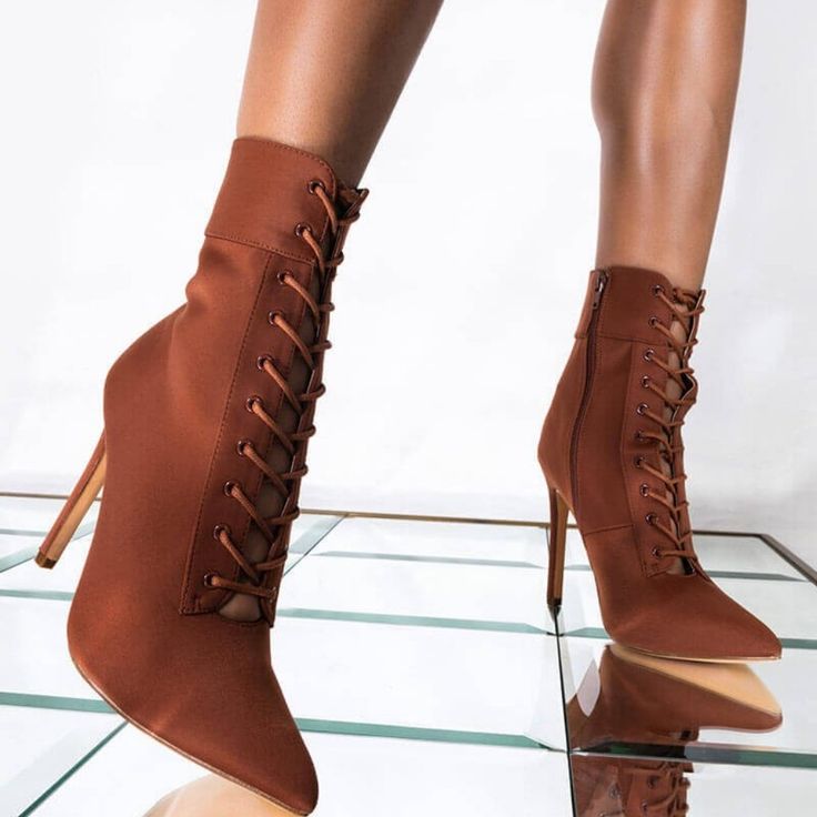 Cognac Stiletto Booties Are Too Good To Snooze On. The Mid-Calf Ankle Bootie Features A Lace Up Front, A Zipper At The Inner Ankle, A Pointed Toe, And A Sky High Stiletto Heel. Easy To Dress Up Or Down, We Especially Love These Boots With A Pair Of High Waisted Cropped Trousers, A Cable Knit Winter Sweater, And A Wide Brim Felt Fedora. Brown High Heel Lace-up Boots For Party, Fall Lace-up Heels With Wrapped Heel, Fitted Heeled Boots With Wrapped Heel For Fall, Brown Fitted Ankle-high Lace-up Boots, Chic Brown Lace-up Boots With Pointed Toe, Brown High Ankle Heels For Spring, Spring Fitted Heeled Boots With Wrapped Heel, Brown Fall Heels For Night Out, Brown Heels For Night Out In Fall