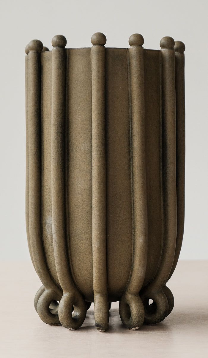 a close up of a vase on a table with many lines in the middle and one line at the bottom