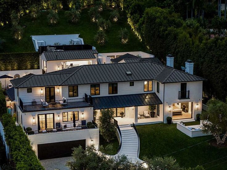 an aerial view of a large white house with lots of windows and stairs leading up to it