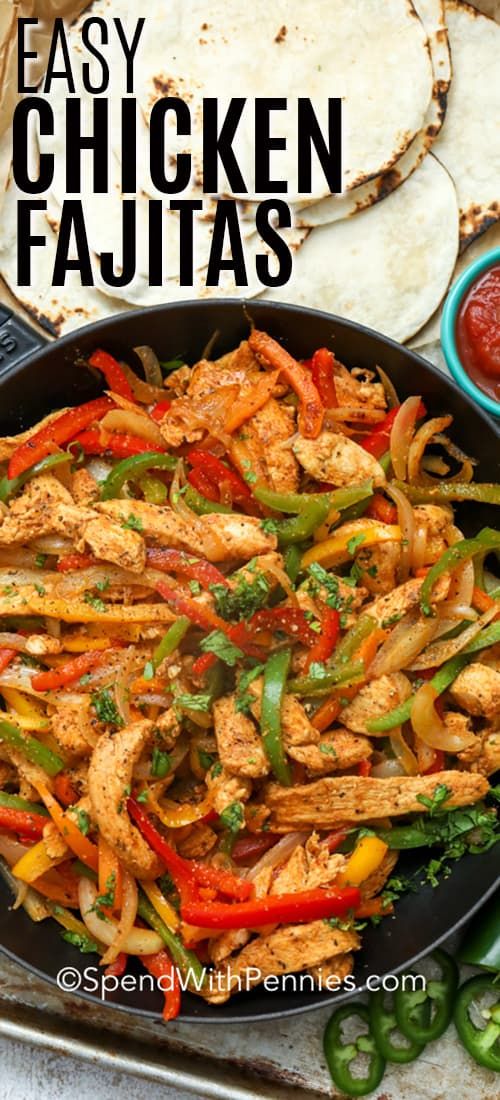 easy chicken fajitas in a skillet with peppers and onions