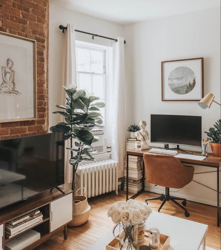 a living room filled with furniture and a flat screen tv sitting on top of a wooden table