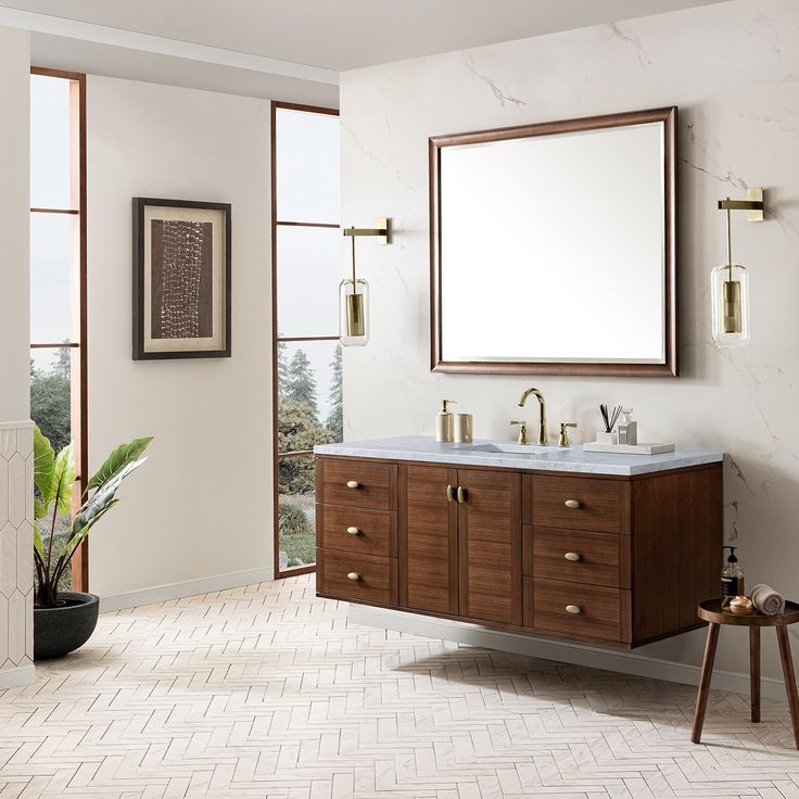 The Mid-Century Modern inspired Amberly collection showcases a rich walnut wood cabinet, set elegantly atop subtly curved legs, and accented with oval Champagne Brass pulls. Floating or freestanding, Amberly is an eye-catching focal point for any luxury bathroom décor. James Martin Vanities Amberly 60-in Mid-century Walnut Undermount Single Sink Floating Bathroom Vanity with Carrara Marble Top in Brown Free Standing Vanity, Console Styling, James Martin Vanity, Bathroom Decor Luxury, Floating Bathroom Vanity, Single Sink Bathroom, James Martin, Small Bath, Floating Vanity