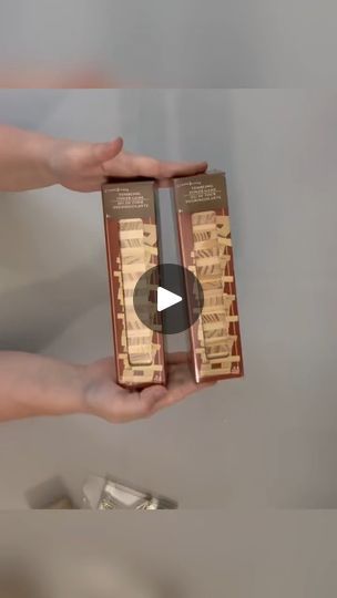 two hands are holding some kind of box