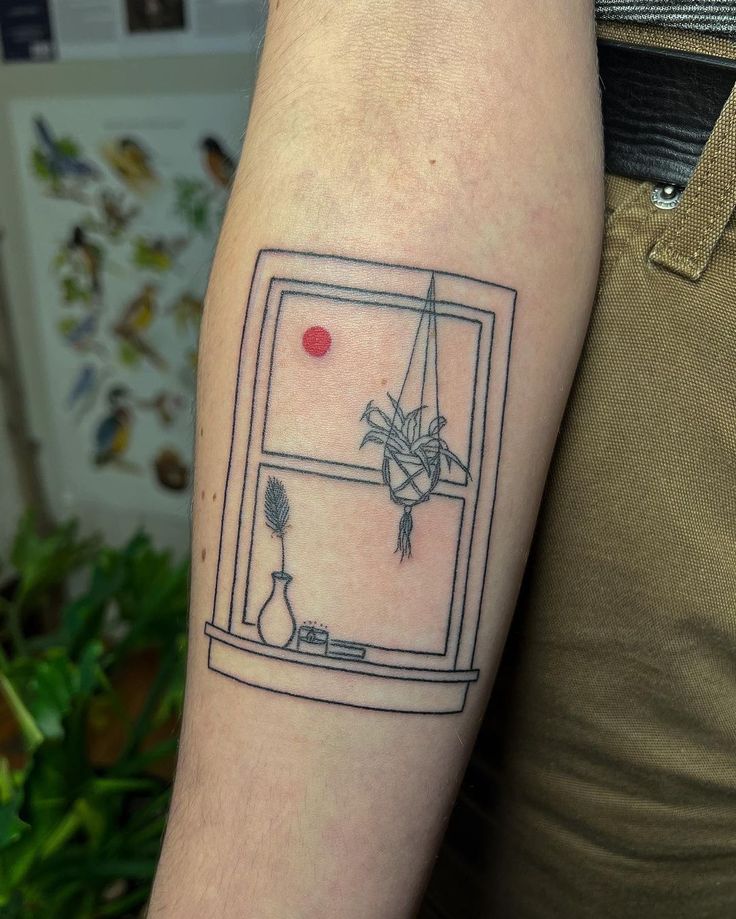 a man with a tattoo on his arm that has a window and vase in it