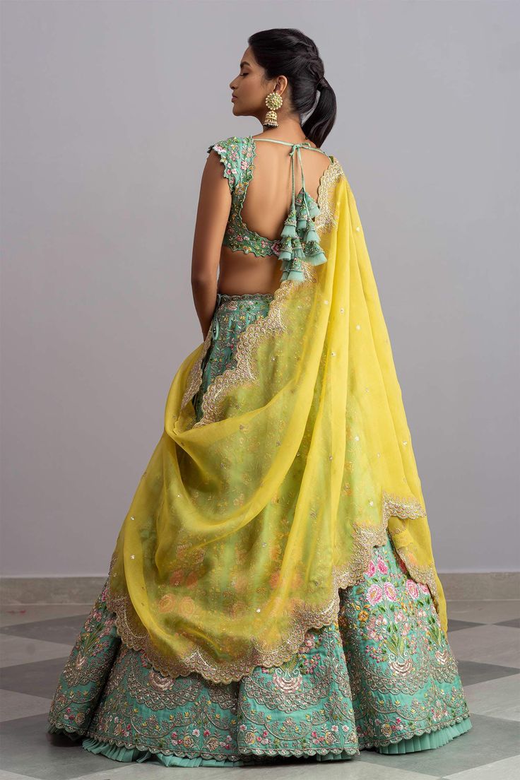 Sea-green organza lehenga with thread work, multi-color floral motifs and scallop hem. Comes with embellished blouse and yellow dupatta.
Components:3
Embroidered
Neckline:V Neck
Sleeve Length:Cap
Fabric:Organza
Color:Green
Plunging neck
Tie-up cutout back
Cutwork detail
Note: Cancan worn by the model is not for sale - Aza Fashions Green Georgette Lehenga With Cutdana, Green Georgette Lehenga With Cutdana Details, Green Tissue Silk Choli With Intricate Embroidery, Green Organza Choli With Intricate Embroidery, Green Chanderi Pre-draped Saree With Intricate Embroidery, Green Organza Lehenga For Reception, Green Organza Traditional Wear For Reception, Designer Green Organza Lehenga, Silk Green Choli With Sheer Dupatta