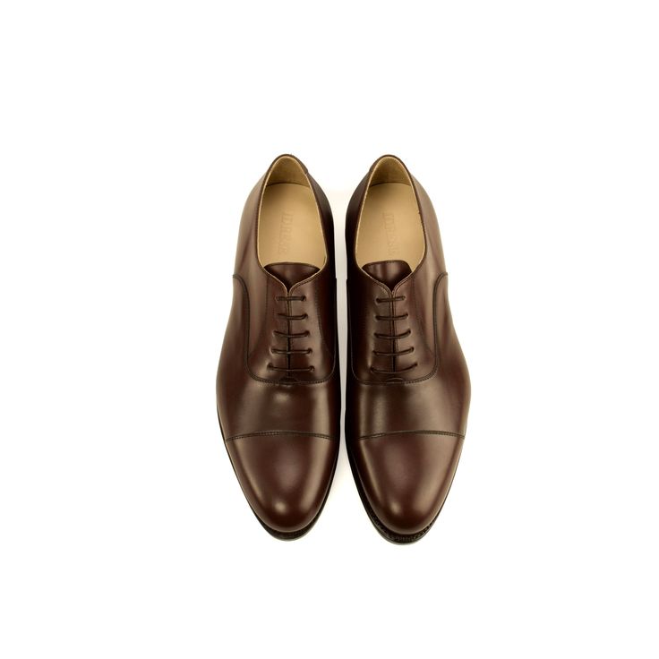 Craftsmanship & Details The dark-brown Oxford is the quintessential shoe for the modern businessman. Clean lines, closed lacing system, and absence of broguing make this a formal shoe. But, it’s equally at home with an Oxford Cloth Button-Down and some jeans as it is with your finest suits. For a shoe you’ll get so much wear out of, you’ll want nothing but the best: Italian leather upper, made in Spain, leather sole with a stack heel and a 360-degree Goodyear welt. Upper: Full-grain Italian leat Business Lace-up Cap Toe Shoes With Goodyear Welting, Timeless Brown Lace-up Oxford Shoes, Timeless Brown Oxford Lace-up Shoes, Timeless Wingtip Oxford Shoes For Business, Elegant Brown Oxford Shoes With Leather Sole, Classic Brown Dress Shoes With Goodyear Welt, Timeless Formal Oxford With Brogue Detailing, Classic Brown Semi-formal Oxfords, Timeless Formal Oxford Shoes With Brogue Detailing