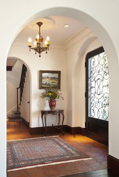 an archway leading to a foyer with a rug on the floor