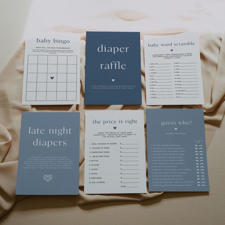 four baby diaper raffle cards laid out on a bed