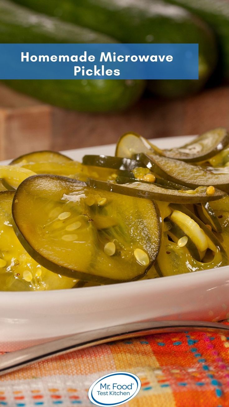 a white bowl filled with pickles on top of a table