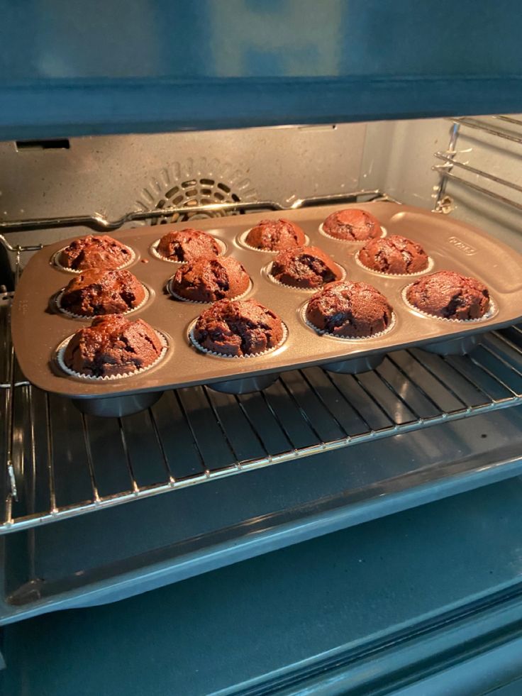 muffins are being cooked in an oven