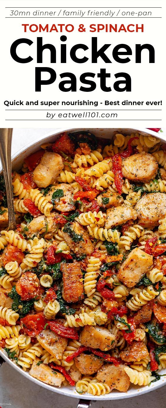 chicken pasta with tomatoes and spinach in a skillet