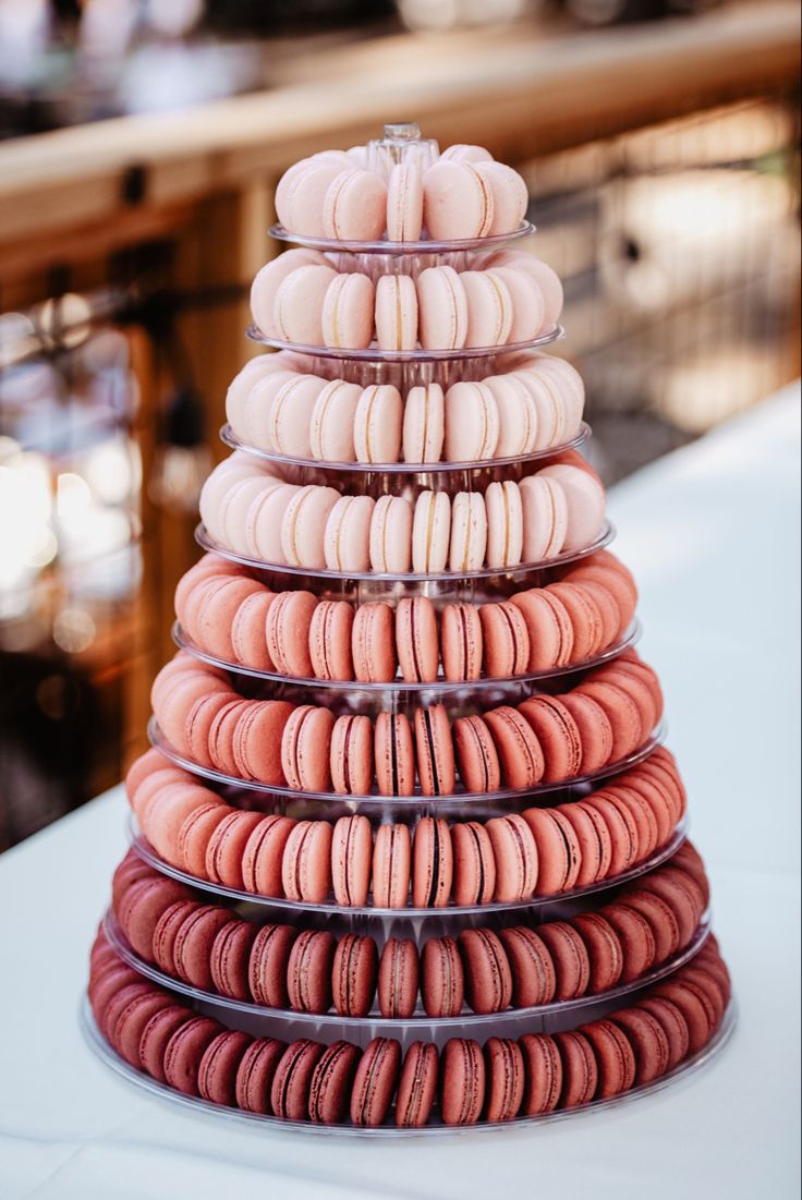 a stack of macaroons sitting on top of a table next to each other