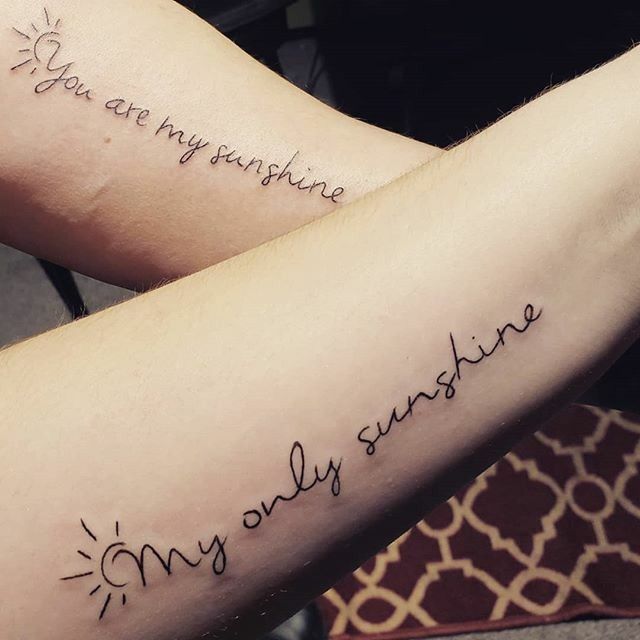 two people with tattoos on their arms saying you are my sunshine